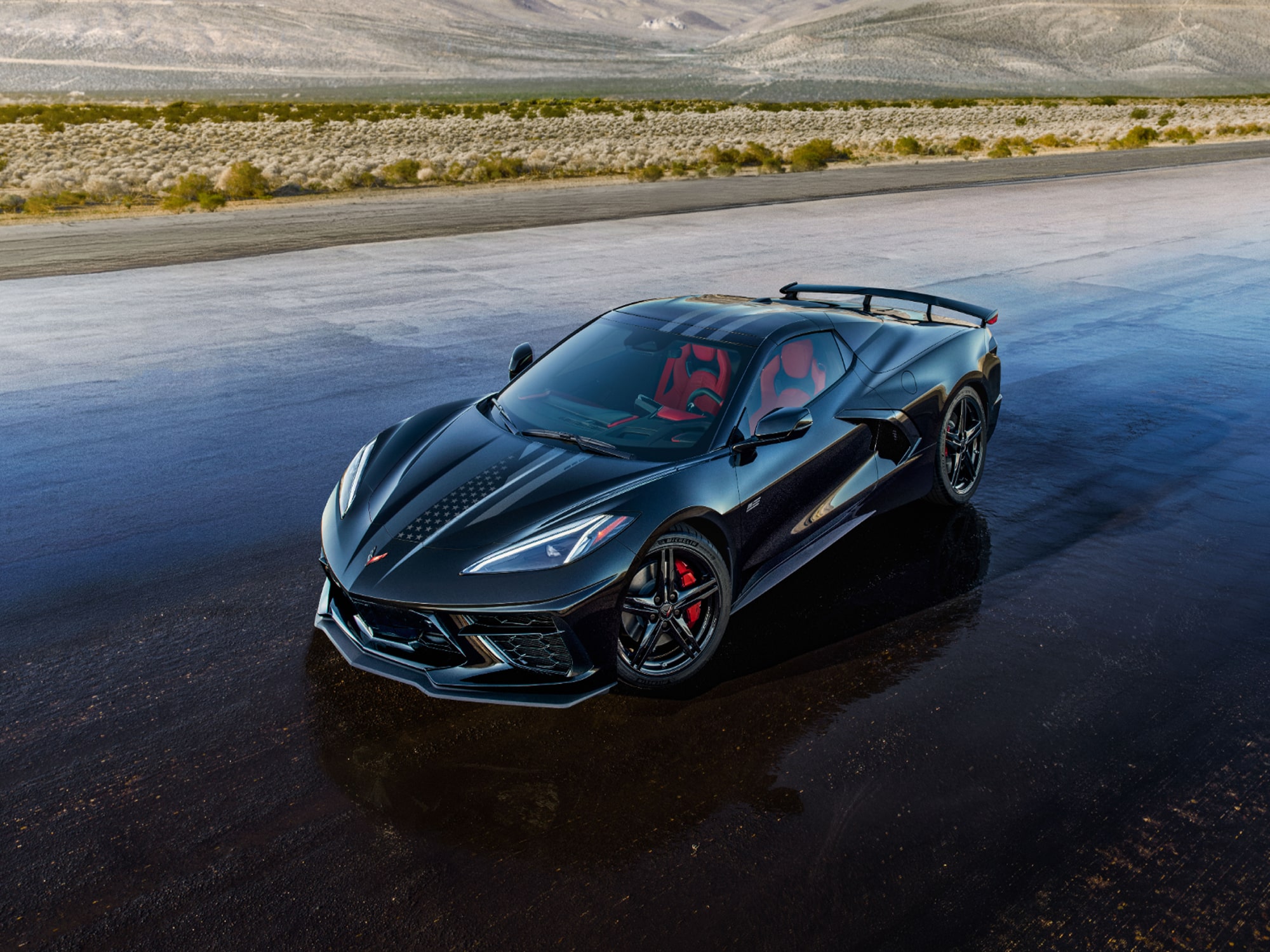 A Dark Blue Chevrolet Corvette Stingray from the Stars and Steel Collection on a Wet Runway.