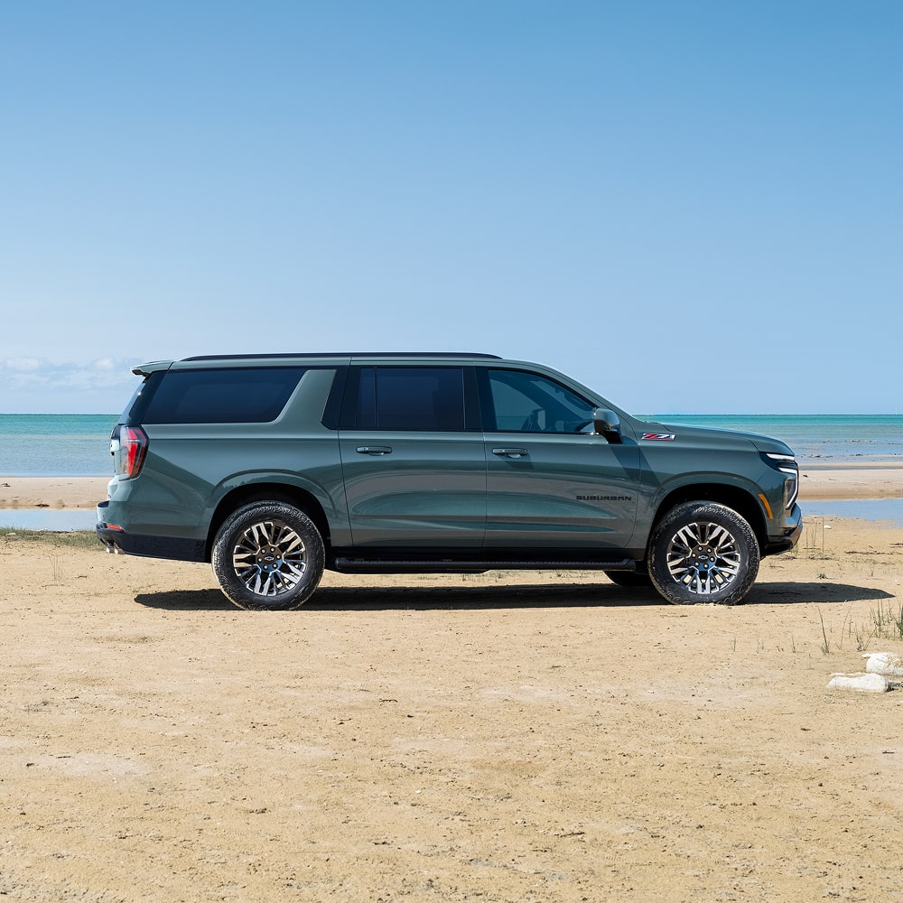 Profile View of the 2026 Chevrolet Suburban SUV Passenger Side Parked Near a Lake