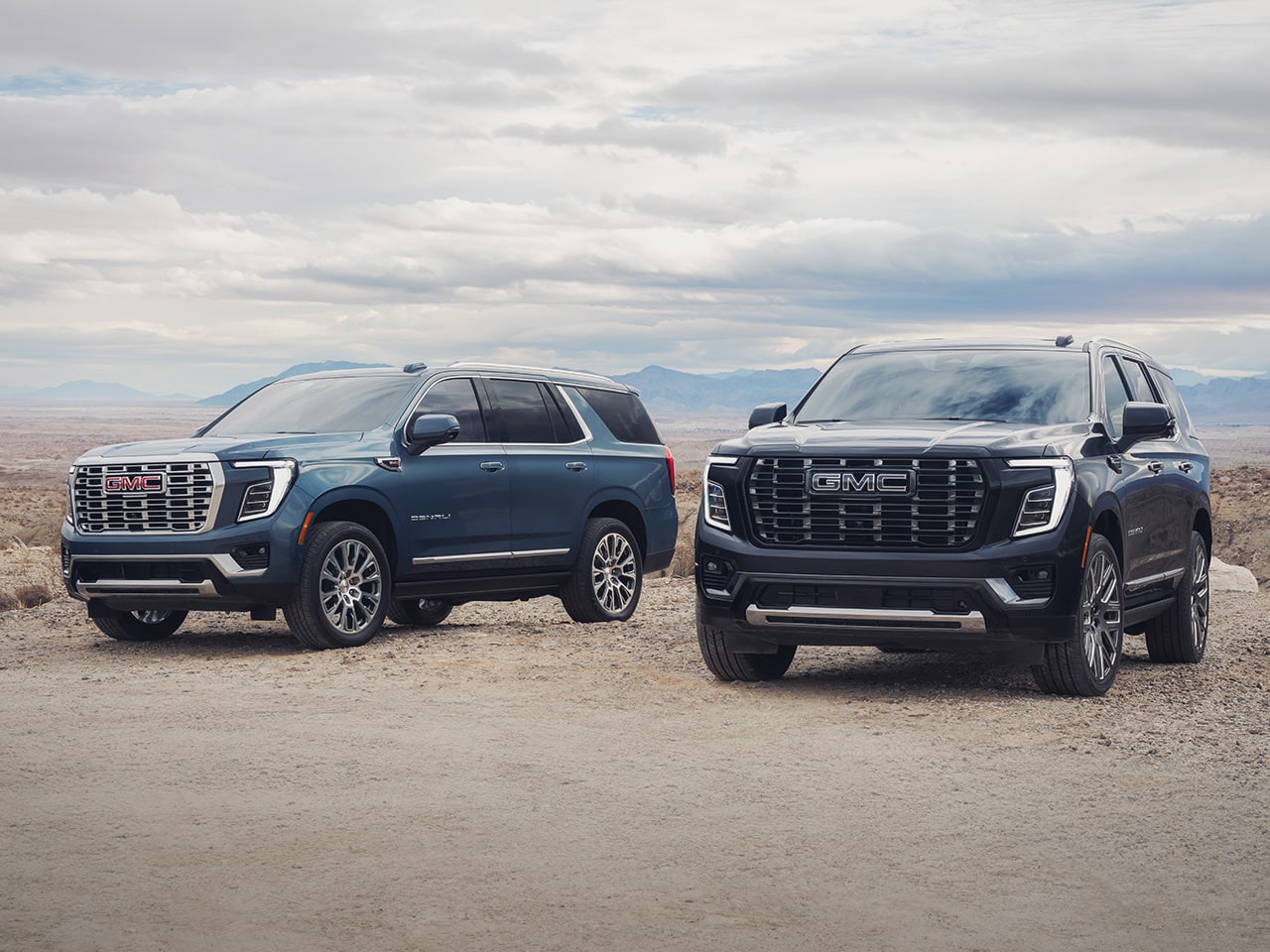 The 2026 GMC Yukon Denali and Denali Ultimate Luxury SUVs Parked Next to Each other on a Beach