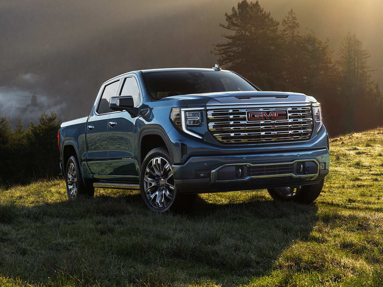 The 2026 GMC Sierra Denali Luxury Pickup Truck Driving Off-Road While Kicking up Dust