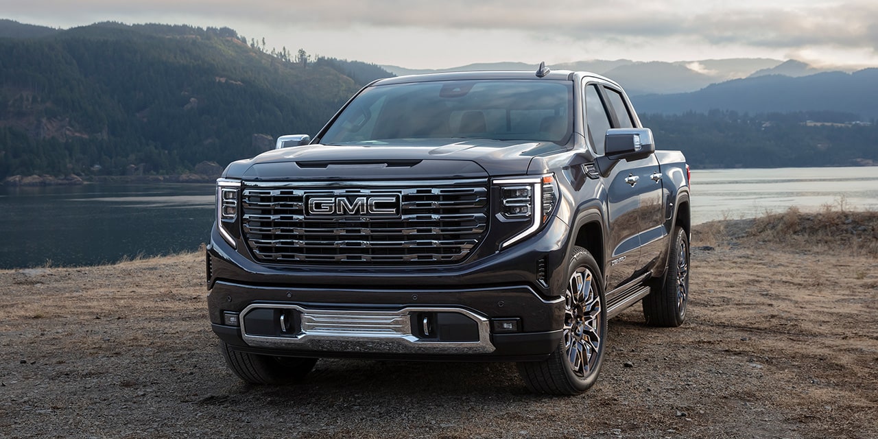 Front Three-Quarters View of the 2026 GMC Sierra 1500 Pickup Truck Parked Near a Body of Water